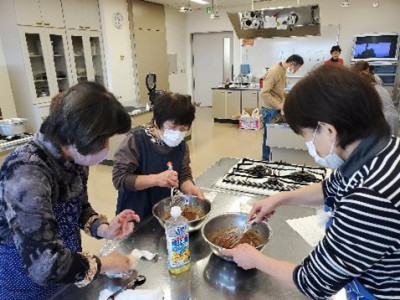 溶かしたチョコレートをかき混ぜてケーキを作っている写真